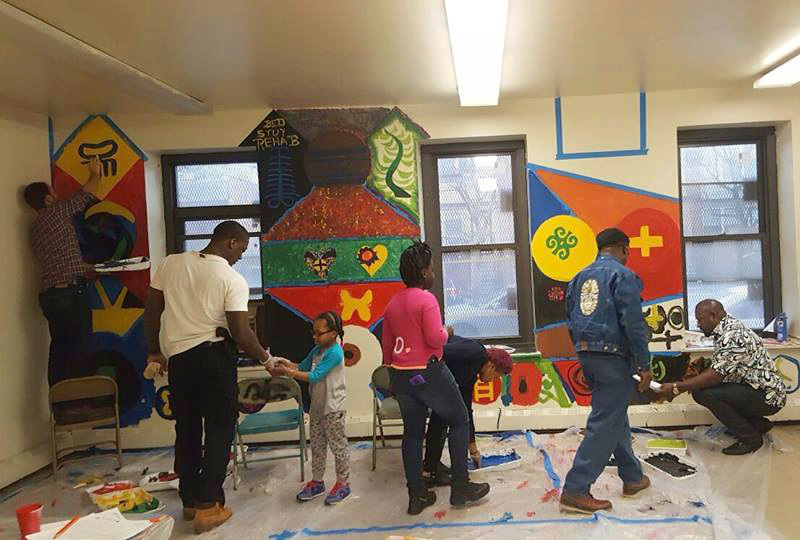 Photo of volunteers painting a community center