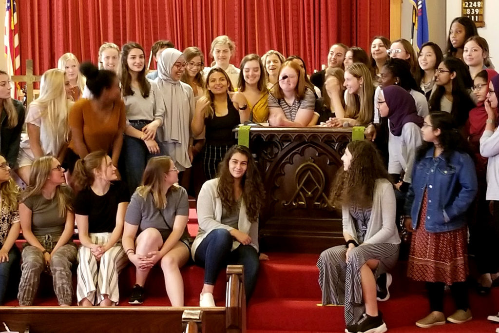 Groups of students pose near a pulpit that Alice Paul spoke from